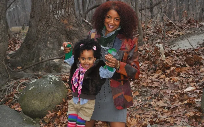 Tami with her young daughter in the autumn woods