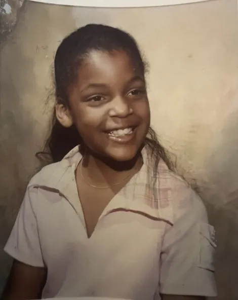 School portrait of young Tami, smiling