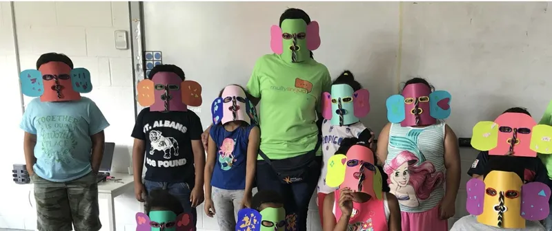 Children in handmade paper masks at a Mully Lingua class